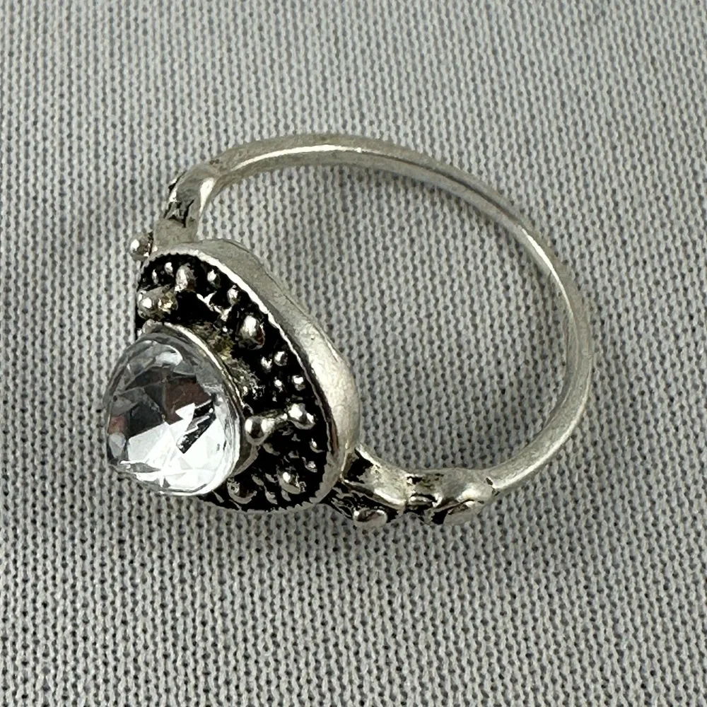 Silver tone ring with a clear teardrop shaped crystal center. - Picture 2 of 4